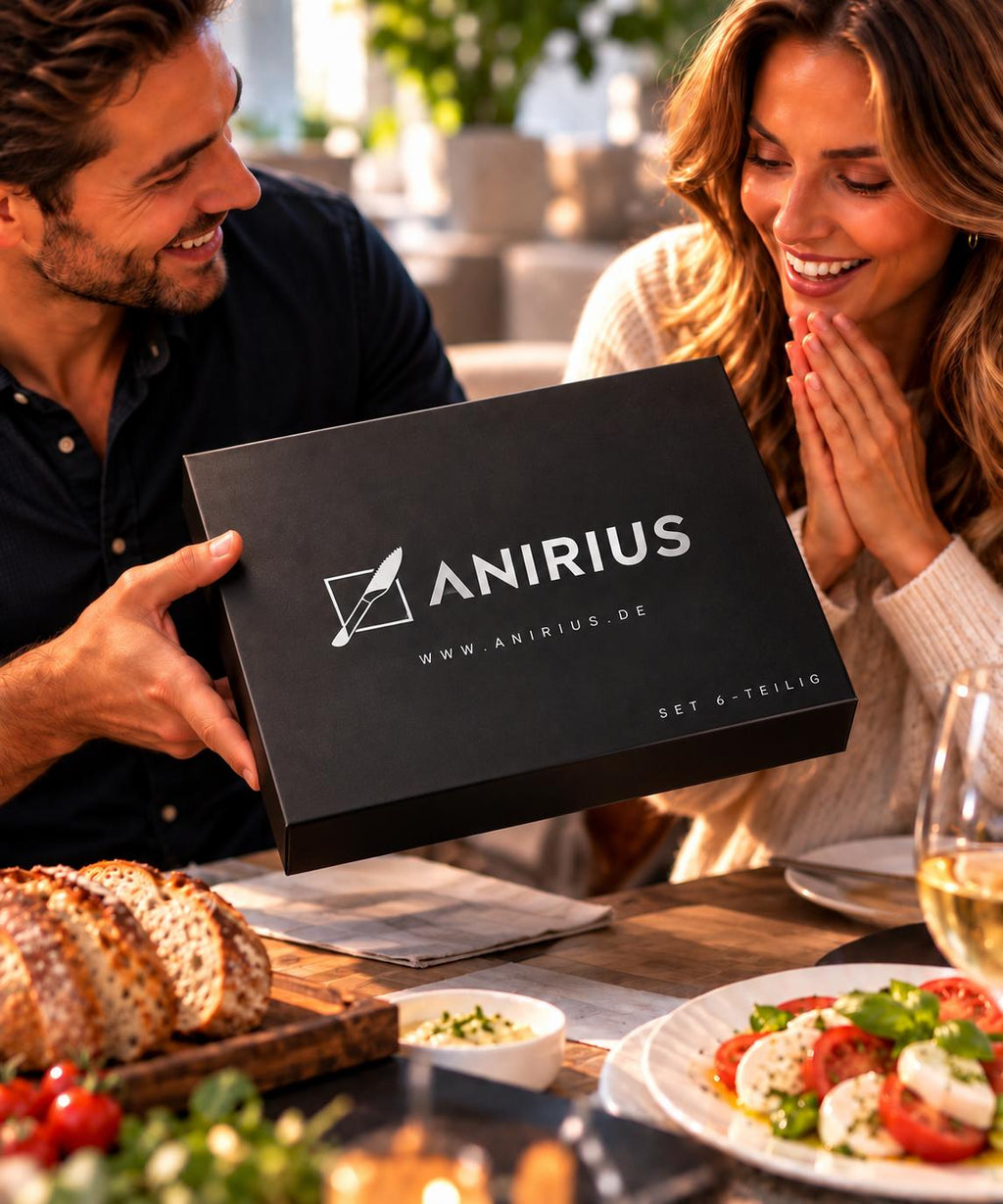 Paar freut sich über die ANIRIUS® Geschenkbox am gedeckten Tisch